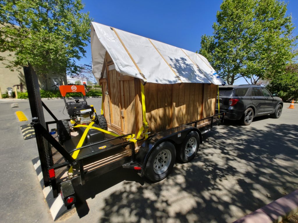 Towing a shed and a brush mower